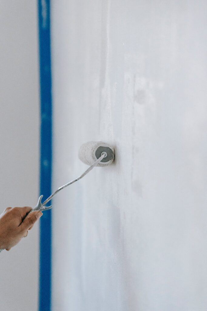 NYC painter painting a wall with a roller